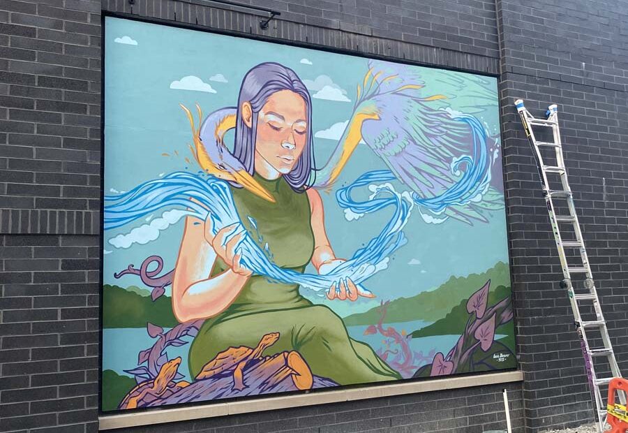 Mural of Woman, River, Crane and Turtles on Building